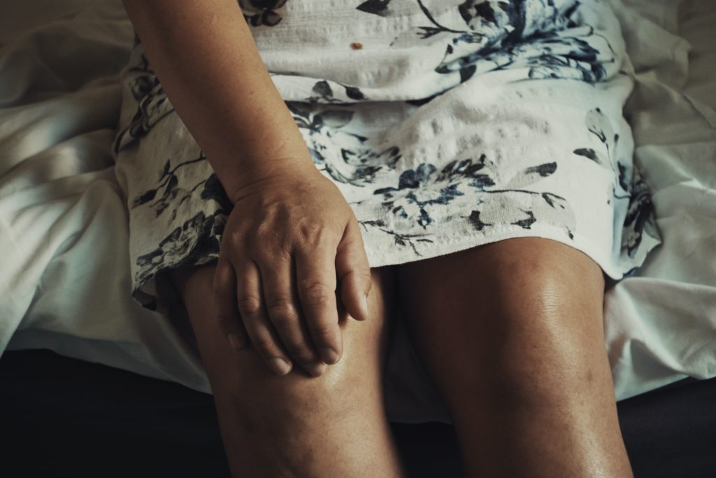 Elderly woman anonymous portrait with knees