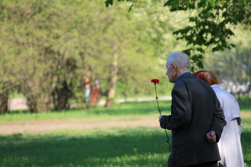 man and woman walking with flower