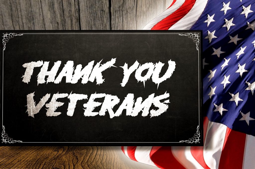 Thank you Veterans sign with US flag in background