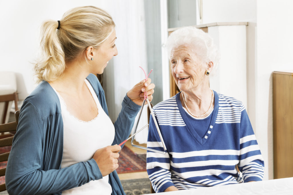 Elderly woman talking with caregiver